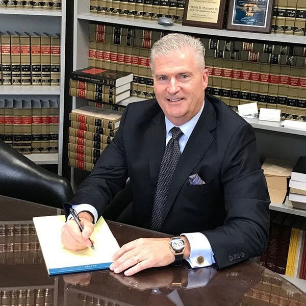 Lawyer Peter S. O'Neill in Glen Burnie, MD, with a backdrop of law books in his office